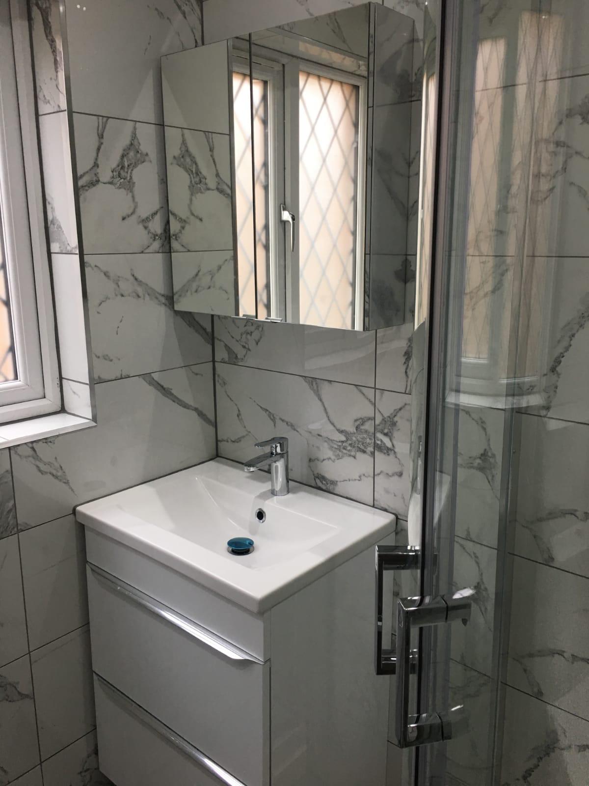 Marble-tiled bathroom refurbishment by United 2 Plumb